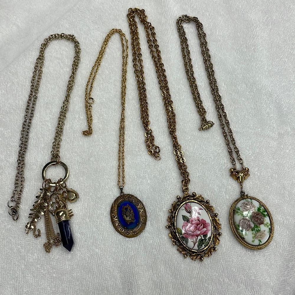Four long necklaces with medallions, unsigned, for wear or repurposing.